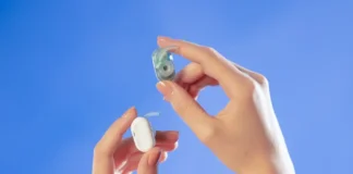 Natura AI HumanPods Your On Demand Life Team hands holding a hearing aid. Natura AI HumanPods. {Tech} for Travel. https://techfortravel.co.uk