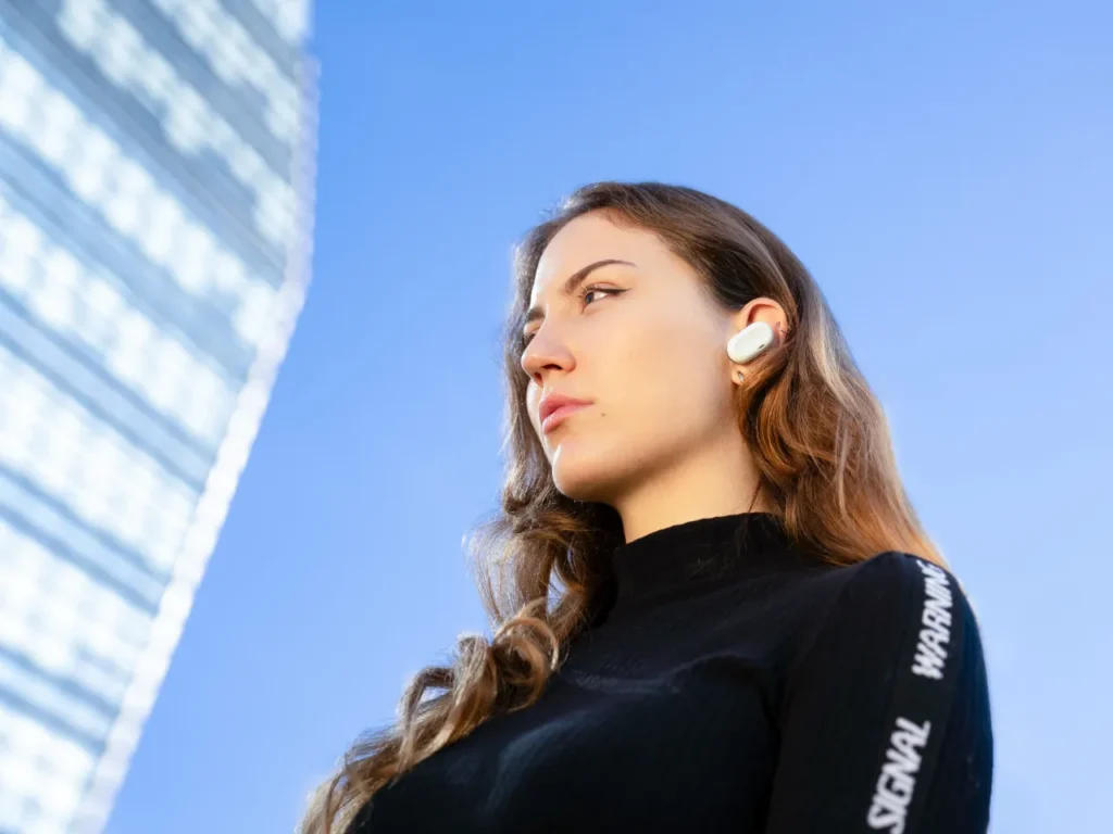 Natura AI HumanPods In-Ear – {Tech} for Travel a woman wearing a black shirt. Natura AI People. {Tech} for Travel. https://techfortravel.co.uk