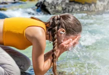 Black Friday Deals 2025: OpenRock Sale Makes It Easy to Go Open-Ear a woman kneeling on a rock with her hands on her face