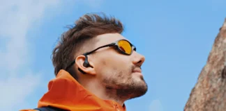 OpenRock S2 Earbuds Review: Built for Wild Adventures a man wearing sunglasses and a backpack. OpenRock S2 Earbuds review. {Tech} for Travel. https://techfortravel.co.uk