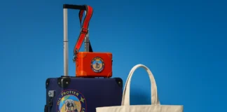 Globe-Trotter Explorer Carry-On headlines new collection a blue suitcase with a red and yellow logo on it. Globe-Trotter Explorer Carry-On collection. {Tech} for Travel. https://techfortravel.co.uk