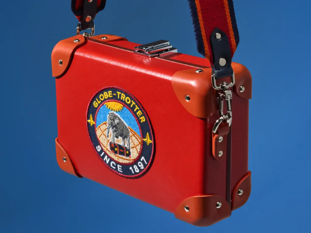 a red suitcase with straps. Globe-Trotter Explorer Carry-On collection. {Tech} for Travel. https://techfortravel.co.uk