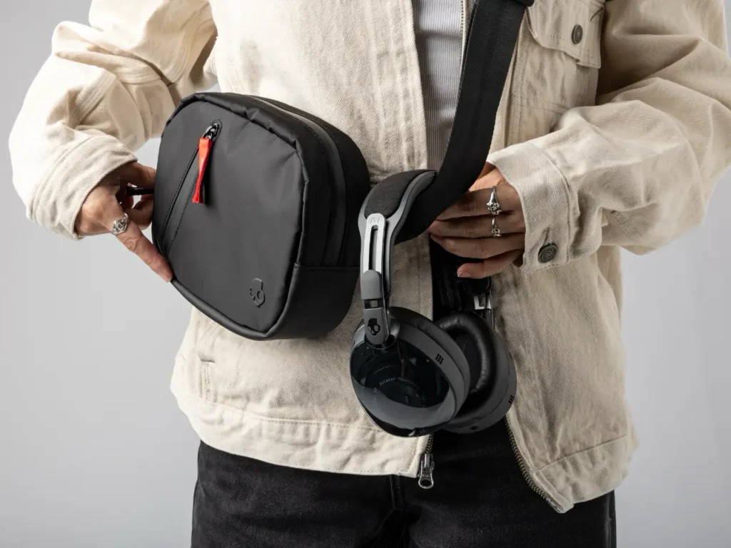 a person holding a bag with headphones around their waist. Skullcandy Aviator 900 Headphones. {Tech} for Travel. https://techfortravel.co.uk