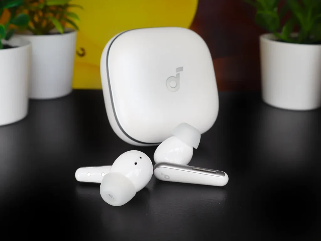 Soundcore Liberty 5 Earbuds Hero1 – {Tech} for Travel a white earbuds on a black surface. Soundcore Liberty 5 review. {Tech} for Travel. https://techfortravel.co.uk