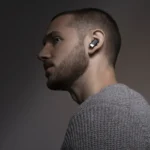 IFA 2025: Debut for Status Audio Pro X Earbuds a man wearing a grey sweater. IFA 2025 news. Status Pro X Earbuds. {Tech} for Travel. https://techfortravel.co.uk