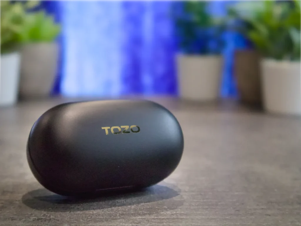 TOZO Golden X1 Case – {Tech} for Travel a black oval object on a table. TOZO Golden X1 Review. {Tech} for Travel. https://techfortravel.co.uk