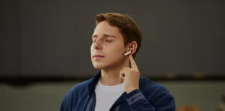 IFA 2025: Bone-conduction sensors make Timekettle W4 AI Translator Earbuds easy to share a man with his eyes closed holding his earbuds to his ear. Timekettle W4 AI Translator Earbuds. {Tech} for Travel. https://techfortravel.co.uk