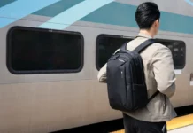 The HyperPack Tech Backpack offers security and style a man with a backpack standing next to a train. HyperPack Tech Backpack. {Tech} for Travel. https://techfortravel.co.uk