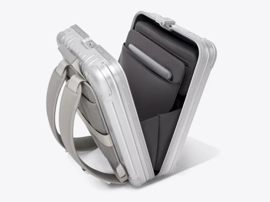 a suitcase with a few objects inside. RIMOWA Original Backpack. {Tech} for Travel. https://techfortravel.co.uk