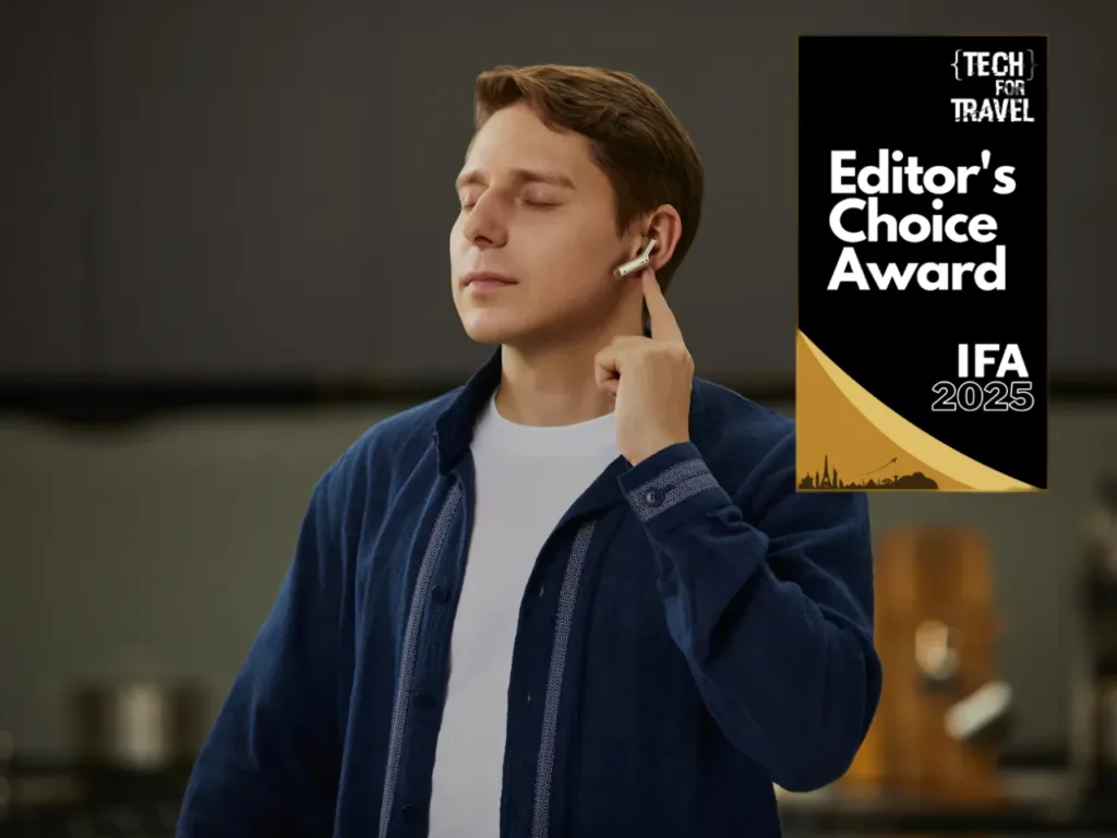 Timekettle W4 AWARD – {Tech} for Travel a man with his eyes closed holding his earbuds to his ear. Best of IFA 2025. {Tech} for Travel. https://techfortravel.co.uk