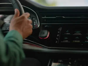 a hand on a steering wheel in a car. speed camera warning device. Tom by TomTom. {Tech} for Travel. https://techfortravel.co.uk