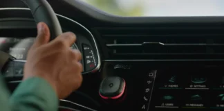 TomTom Unveils Traveller Friendly Speed Camera Warning Device a hand on a steering wheel in a car. speed camera warning device. Tom by TomTom. {Tech} for Travel. https://techfortravel.co.uk