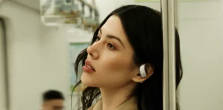 IFA 2025: Clear sound and instant recording with viaim OpenNote Earphones a woman with earbuds leaning against a pole. viaim opennote earphones. {Tech} for Travel. https://techfortravel.co.uk