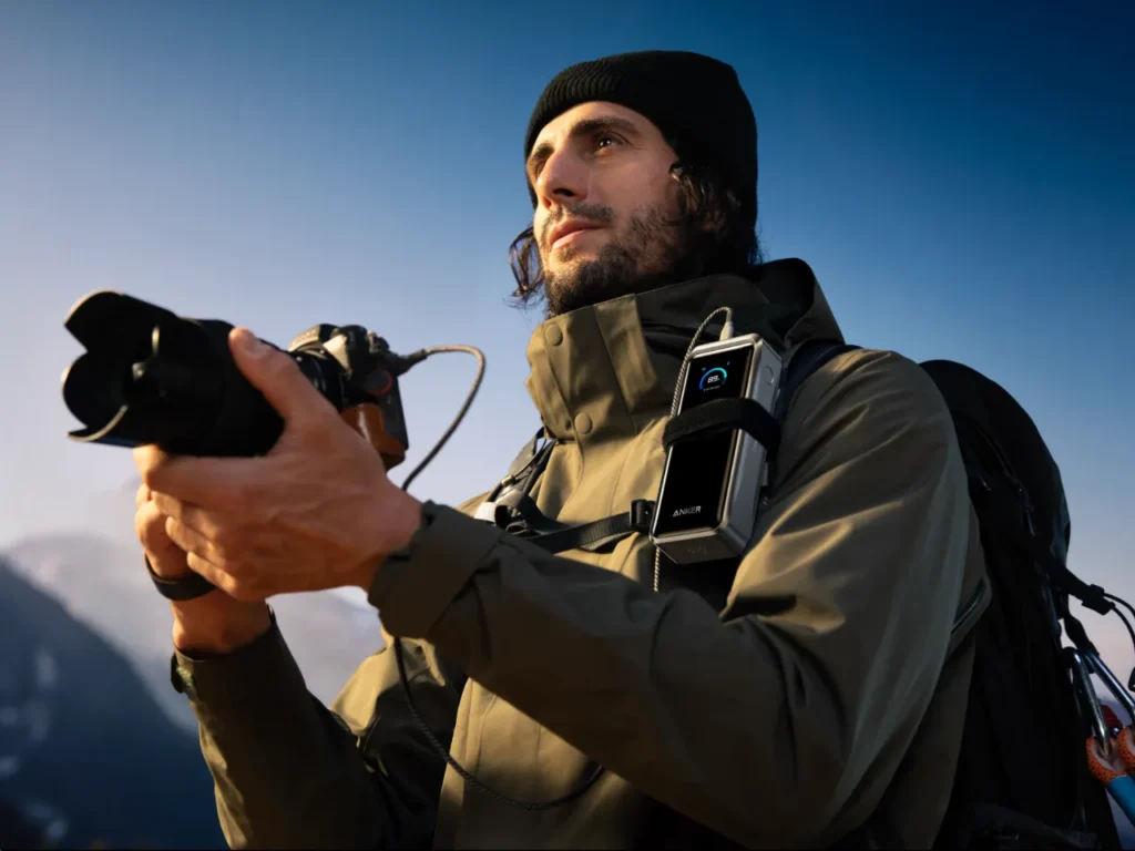 Anker Prime Power Bank Lifestyle – {Tech} for Travel a man holding a camera. Anker Prime Power Bank. {Tech} for Travel. https://techfortravel.co.uk