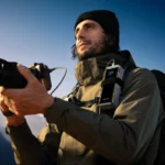a man holding a camera. Anker Prime Power Bank. {Tech} for Travel. https://techfortravel.co.uk