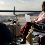 14 inch Apple MacBook Pro M5 confirmed with M5 chip a woman sitting in an airport with a laptop. Apple MacBook Pro M5. {Tech} for Travel. https://techfortravel.co.uk