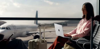 14 inch Apple MacBook Pro M5 confirmed with M5 chip a woman sitting in an airport with a laptop. Apple MacBook Pro M5. {Tech} for Travel. https://techfortravel.co.uk