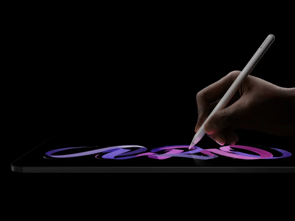 Apple iPad Pro M5 Apple Pencil – {Tech} for Travel a hand holding a stylus and writing on a tablet. Apple iPad Pro M5. {Tech} for Travel. https://techfortravel.co.uk
