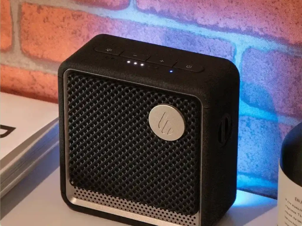 Edifier ES20 Speaker in Black – {Tech} for Travel a black square speaker with a blue light on it. Edifier ES20 Speaker Review. {Tech} for Travel. https://techfortravel.co.uk