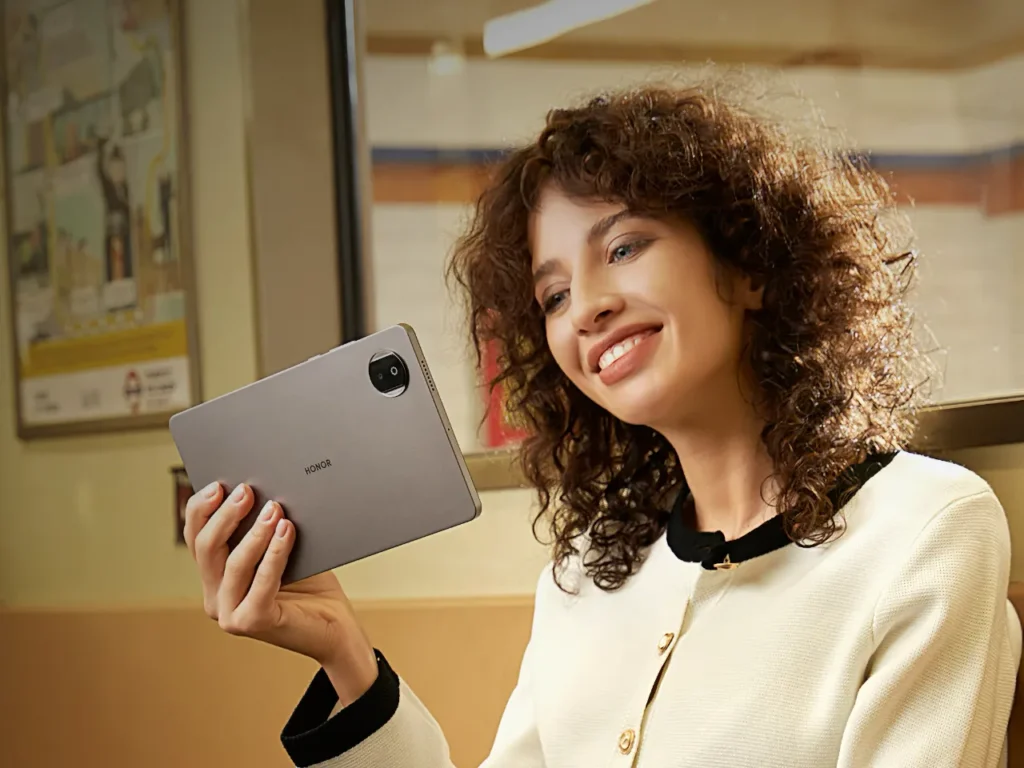 a woman holding a tablet. HONOR 400 Pro. {Tech} for Travel. https://techfortravel.co.uk