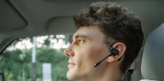 OpenRock Link 20 Earbuds Launch with Magnetic Boom Mic a man wearing a headset in a car. OpenRock Link 20 Earbuds. {Tech} for Travel. https://techfortravel.co.uk