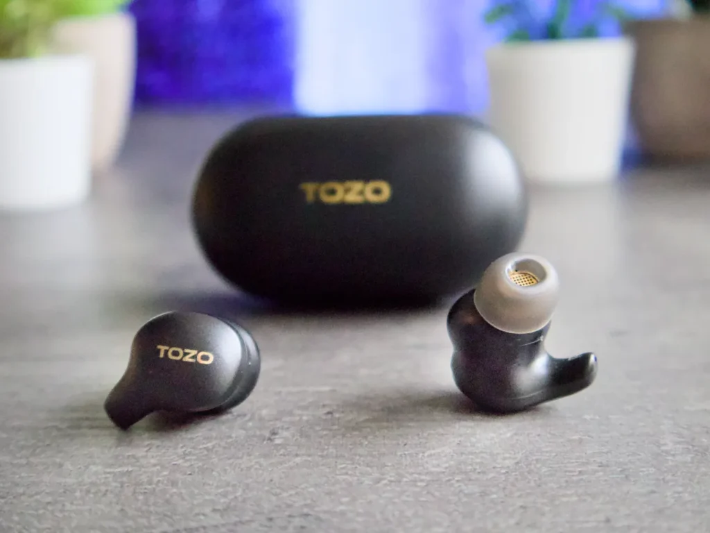 TOZO Golden X1 Earbuds Fit – {Tech} for Travel a pair of black earbuds. TOZO Golden X1 Review. {Tech} for Travel. https://techfortravel.co.uk