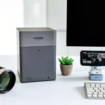 UGREEN NASync DH4300 Plus Review: The Traveller’s Personal Cloud Companion a computer monitor and camera on a desk. UGREEN NASync DH4300 Plus Review. {Tech} for Travel. https://techfortravel.co.uk