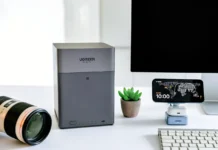 UGREEN NASync DH4300 Plus Review: The Traveller’s Personal Cloud Companion a computer monitor and camera on a desk. UGREEN NASync DH4300 Plus Review. {Tech} for Travel. https://techfortravel.co.uk