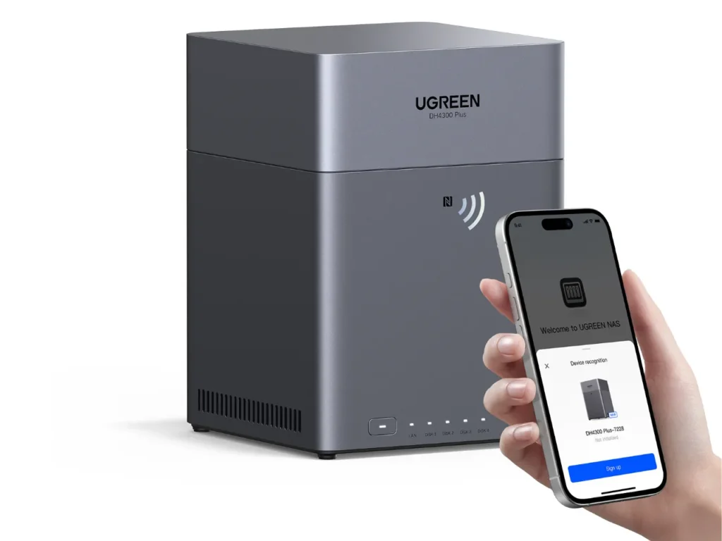 UGREEN DH4300 Plus NFC – {Tech} for Travel a hand holding a phone next to a machine. UGREEN NASync DH4300 Plus Review. {Tech} for Travel. https://techfortravel.co.uk