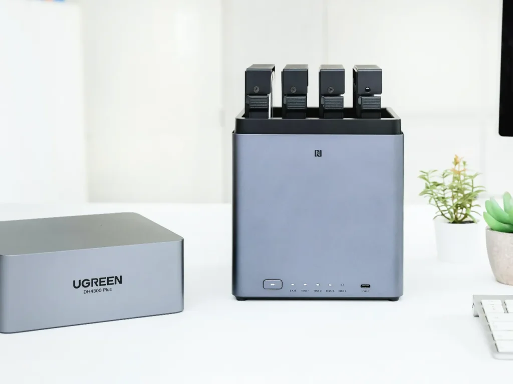 UGREEN DH4300 Plus Top Cover – {Tech} for Travel a rectangular device with four rectangular objects in it. UGREEN NASync DH4300 Plus Review. {Tech} for Travel. https://techfortravel.co.uk