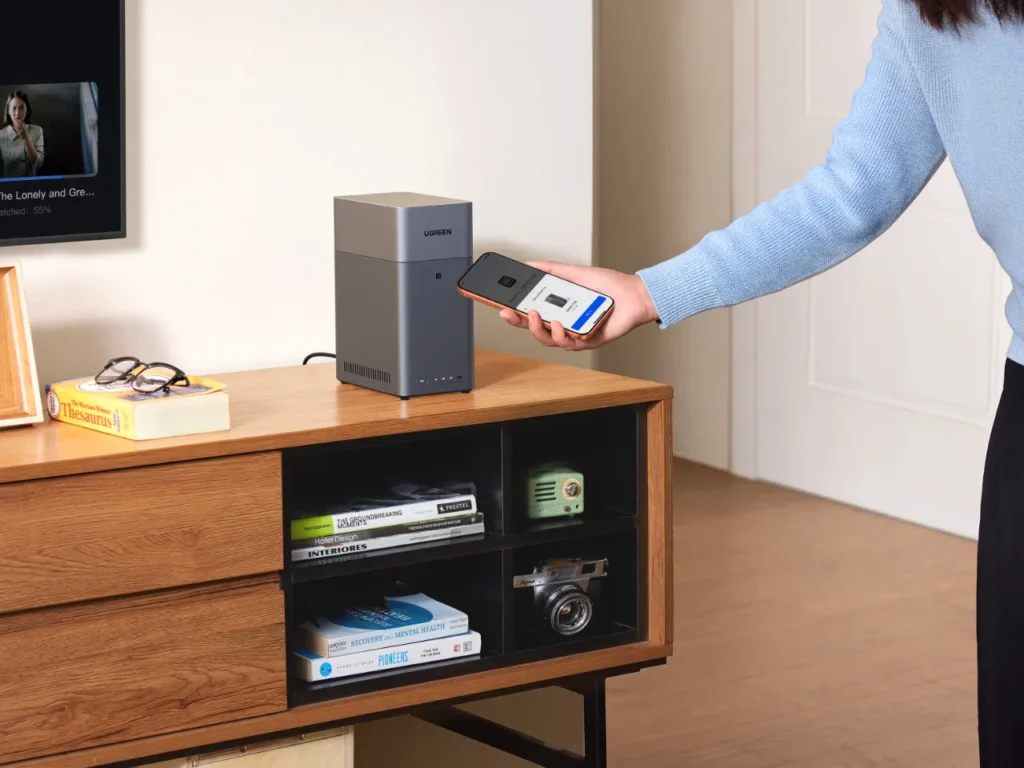 UGREEN NASync DH2300 NFC – {Tech} for Travel a person holding a phone. UGREEN NASync Dh2300. {Tech} for Travel. https://techfortravel.co.uk