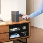 a person holding a phone. UGREEN NASync Dh2300. {Tech} for Travel. https://techfortravel.co.uk