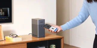 UGREEN NASync DH2300 Simplifies Travel Photo Backups a person holding a phone. UGREEN NASync Dh2300. {Tech} for Travel. https://techfortravel.co.uk