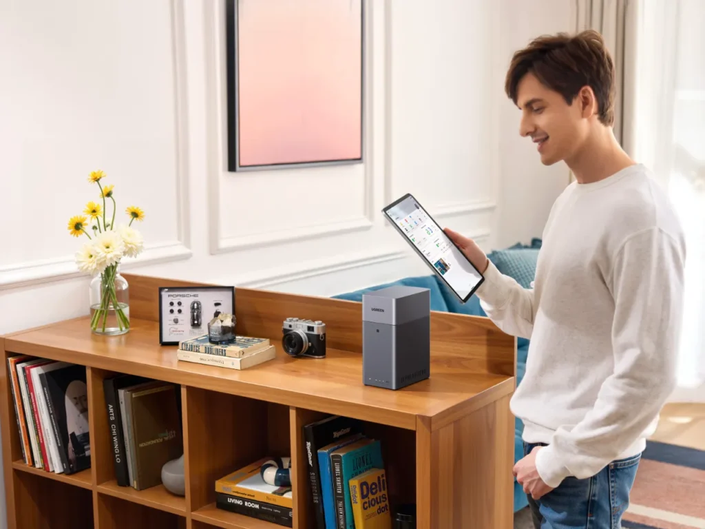 UGREEN NASync DH2300 Remote Access – {Tech} for Travel a man looking at a tablet. UGREEN NASync Dh2300. {Tech} for Travel. https://techfortravel.co.uk