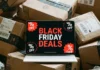 Guide to the best Black Friday travel gadget deals for 2025 a laptop with a black screen on top of boxes. Black Friday Deals 2025. {Tech} for Travel. https://techfortravel.co.uk