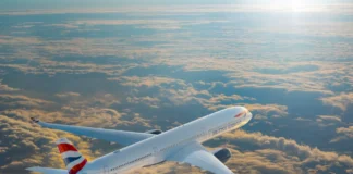 British Airways Wi-Fi to Be Free for All with Starlink an airplane flying above clouds. British Airways Wi-Fi. {Tech} for Travel. https://techfortravel.co.uk