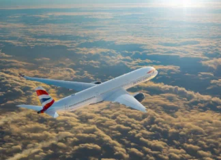 British Airways Wi-Fi to Be Free for All with Starlink an airplane flying above clouds. British Airways Wi-Fi. {Tech} for Travel. https://techfortravel.co.uk