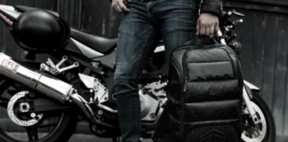 Black Friday Deals 2025: STM Goods takes 40% off everything a person holding a backpack next to a motorcycle. Black Friday Deals 2025