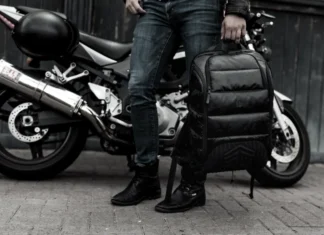 Black Friday Deals 2025: STM Goods takes 40% off everything a person holding a backpack next to a motorcycle. Black Friday Deals 2025