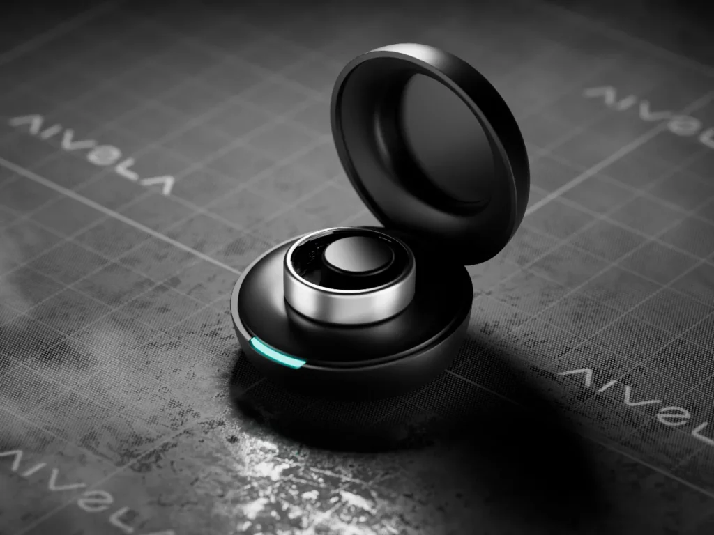 a black and silver earbuds on a graph paper. Aivela Ring Pro. CES 2026. {Tech} for Travel. https://techfortravel.co.uk