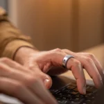 Wearable upgrade Aivela Ring Pro launches with 8 touch and 6 air gestures a person using a laptop. Aivela Ring Pro. CES 2026. {Tech} for Travel. https://techfortravel.co.uk