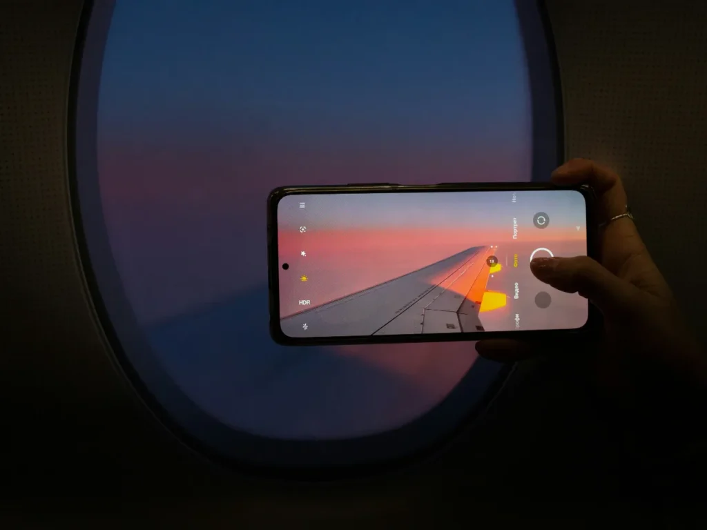 a hand holding a phone with a picture of a road
