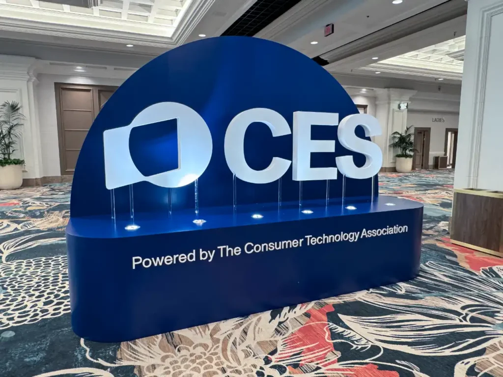 CES 2025 Logo – {Tech} for Travel a blue sign with white text and a logo on it. CES 2026. {Tech} for Travel. https://techfortravel.co.uk