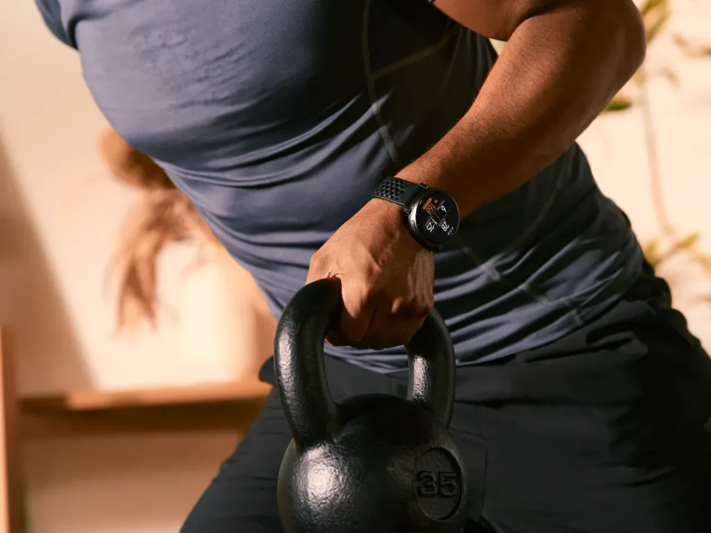 Amazfit Active Max Weights – {Tech} for Travel a person holding a kettlebell. Amazfit Active Max. {Tech} for Travel. https://techfortravel.co.uk
