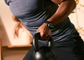 AI training Amazfit Active Max brings Zepp Coach to workouts a person holding a kettlebell. Amazfit Active Max. {Tech} for Travel. https://techfortravel.co.uk