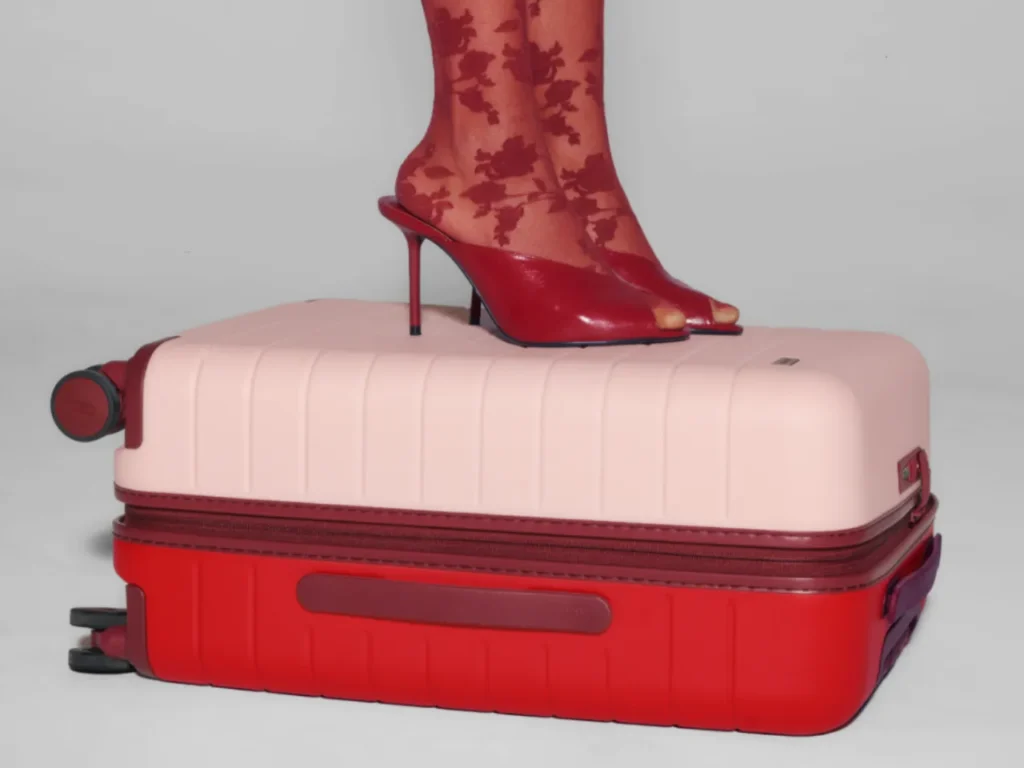 a person's feet on a suitcase. Away Limited Edition Bigger Carry-on. {Tech} for Travel. https://techfortravel.co.uk