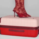 Away Limited Edition Carry-on drops for Valentine’s Day a person's feet on a suitcase. Away Limited Edition Bigger Carry-on. {Tech} for Travel. https://techfortravel.co.uk