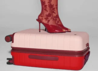Away Limited Edition Carry-on drops for Valentine’s Day a person's feet on a suitcase. Away Limited Edition Bigger Carry-on. {Tech} for Travel. https://techfortravel.co.uk