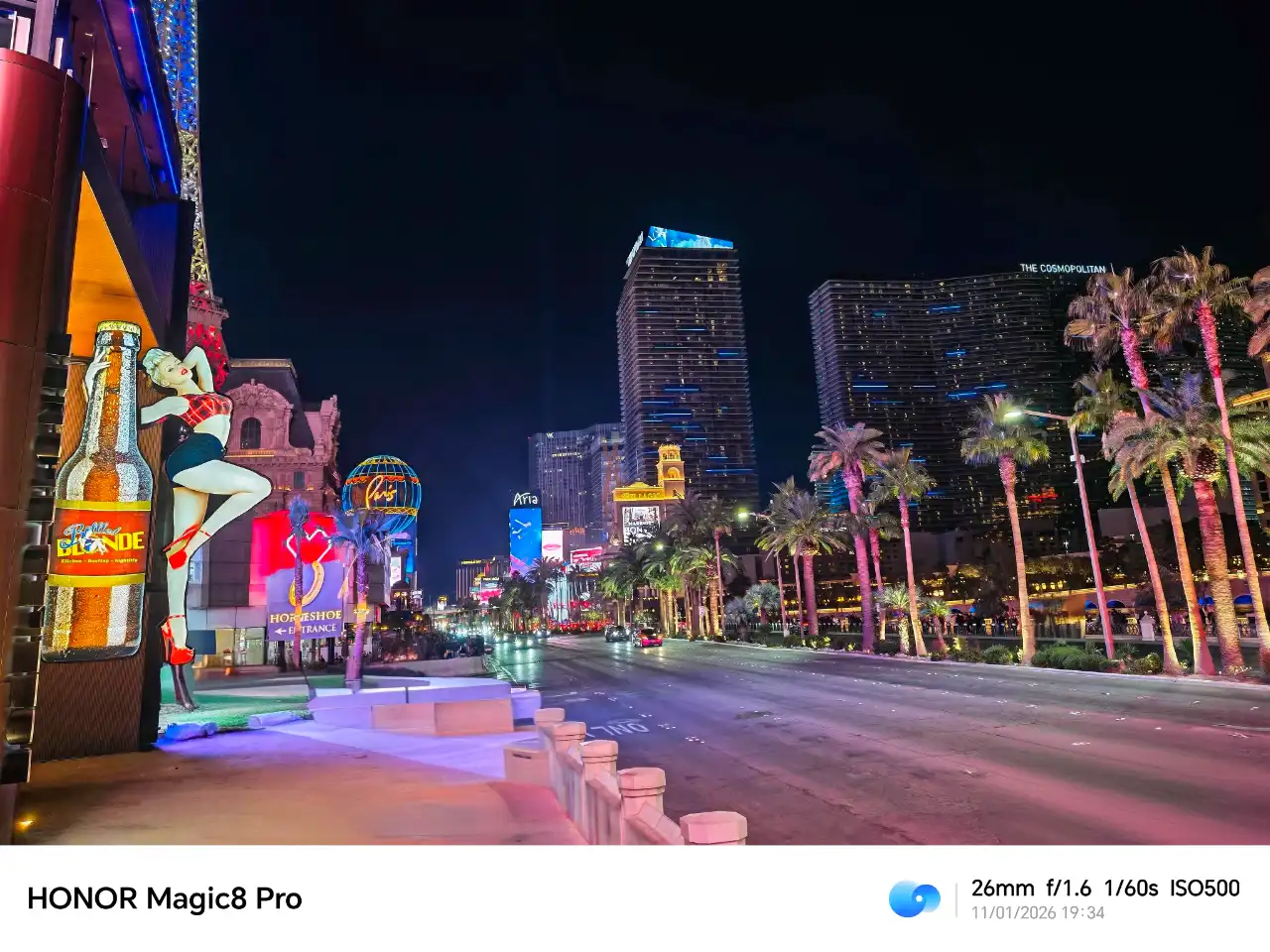a city street with tall buildings and a woman statue