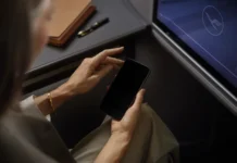 Lufthansa Wi-Fi boosted by new Starlink collaboration a person holding a phone. Lufthansa Wi-Fi. {Tech} for Travel. https://techfortravel.co.uk